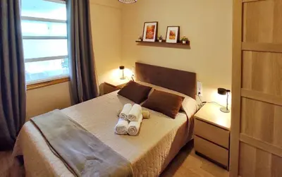 a bedroom with a bed with a towel on it at Apartamento en Betanzos in Betanzos