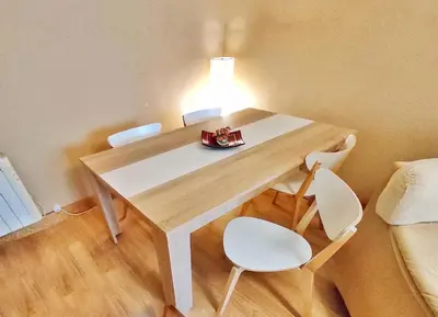a table with chairs and a lamp on top of it at Apartamento en Betanzos in Betanzos