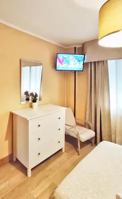 a bedroom with a dresser and a tv on the wall at Apartamento en Betanzos in Betanzos