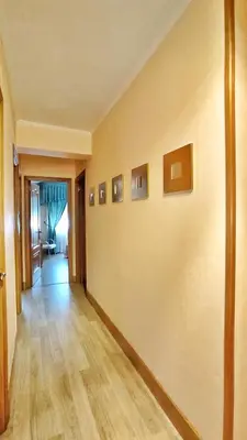 an empty hallway with paintings on the wall at Apartamento en Betanzos in Betanzos