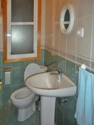 a bathroom with a sink and a toilet and a mirror at Apartamento en Betanzos in Betanzos