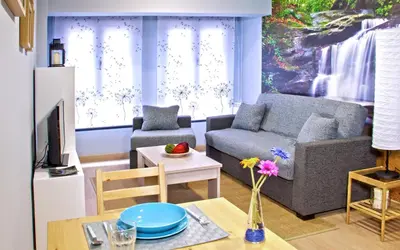 a living room with a couch and a table at Aire de Sanabria in El Puente