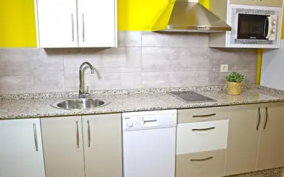 a kitchen with white cabinets and a sink at Aire de Sanabria in El Puente