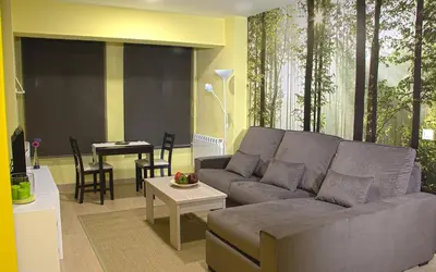 a living room with a couch and a table at Aire de Sanabria in El Puente