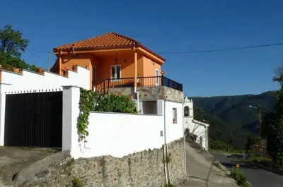 a house on a hill with a white fence at Casa en la Ribeira Sacra, Pombeiro in Lago