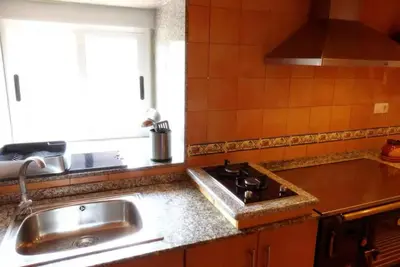 a kitchen with a sink and a stove and a window at Casa en la Ribeira Sacra, Pombeiro in Lago