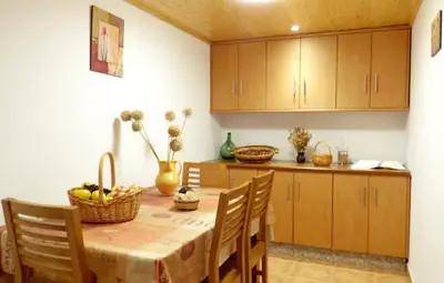 a kitchen with a table with a basket of fruit on it at Casa en la Ribeira Sacra, Pombeiro in Lago
