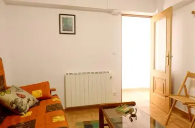 a living room with a couch and a glass table at Casa en la Ribeira Sacra, Pombeiro in Lago