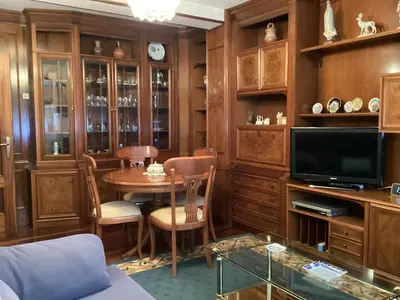 a living room with a table and a tv at Casa Cancelas in Santiago de Compostela
