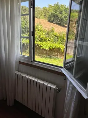 a window with a radiator and a view of a field at Casa Cancelas in Santiago de Compostela