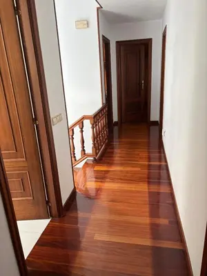 a hallway with wooden floors and wooden doors at Casa Cancelas in Santiago de Compostela