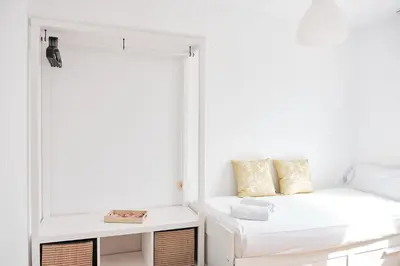 a room with two beds and a table at 9Estudio Sightviews in Santiago de Compostela