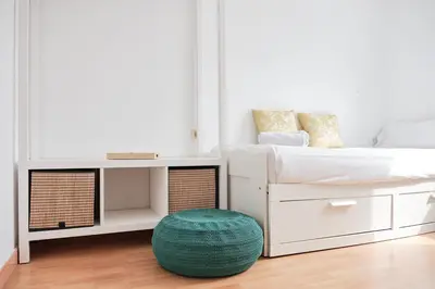 a white bedroom with a bed and a table at 9Estudio Sightviews in Santiago de Compostela