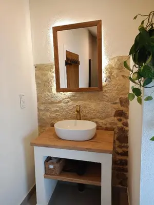 a bathroom with a sink and a mirror on a counter at Ao Carón do Camiño in Padrón