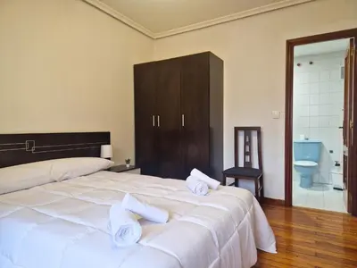 a bedroom with a large white bed with white pillows at YourHouse Progreso 1 apartment in Ourense