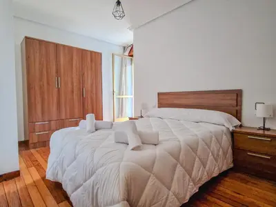 a large white bed in a bedroom with a window at YourHouse Progreso 1 apartment in Ourense