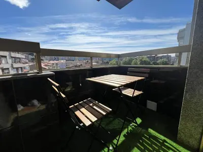a table and chairs on a balcony with a view at YourHouse Progreso 1 apartment in Ourense