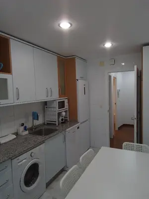 a bathroom with a sink and a toilet and a mirror at A Pia da Moura in Ourense