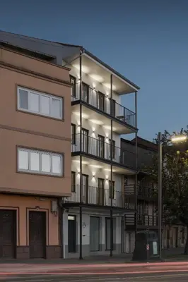 an apartment building with balconies on the side of it at Avós Apartamentos in Monforte de Lemos