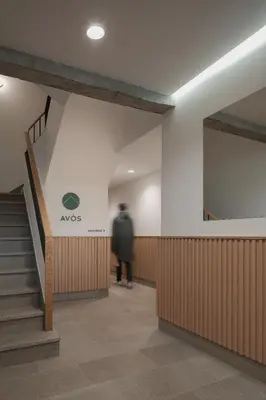a person walking down the stairs in a building at Avós Apartamentos in Monforte de Lemos