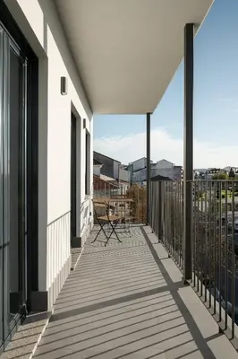 a balcony with a table and chairs on it at Avós Apartamentos in Monforte de Lemos
