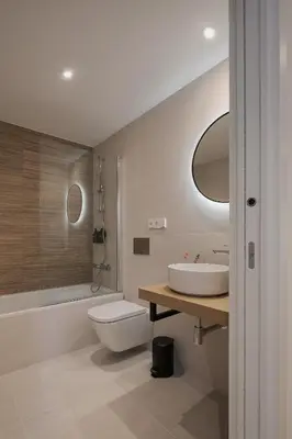 a bathroom with a sink and a toilet and a shower at Avós Apartamentos in Monforte de Lemos