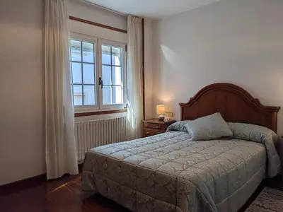 a bedroom with a bed and a window at Casa Filomena in Santiago de Compostela