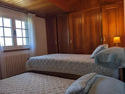 a bedroom with two beds and a window at Casa Filomena in Santiago de Compostela