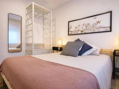 a bedroom with a large bed and a mirror at Alojamientos 