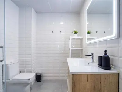 a bathroom with a sink and a toilet and a mirror at Alojamientos 