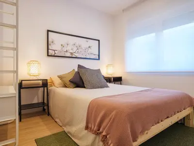 a bedroom with a large bed and a window at Alojamientos 