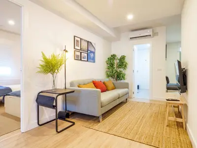 a living room with a couch and a television at Alojamientos 