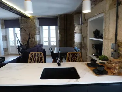 a living room with a table with a laptop on a counter at Foroplaza Duplex in Lugo