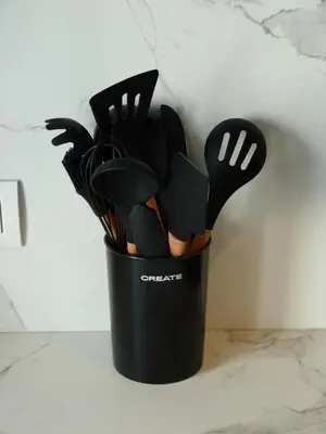 a black container filled with utensils on a counter at Foroplaza Duplex in Lugo