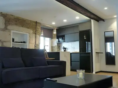 a living room with a couch and a table at Foroplaza Duplex in Lugo