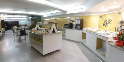 a restaurant kitchen with a counter with some food at Nest Style Santiago in Santiago de Compostela