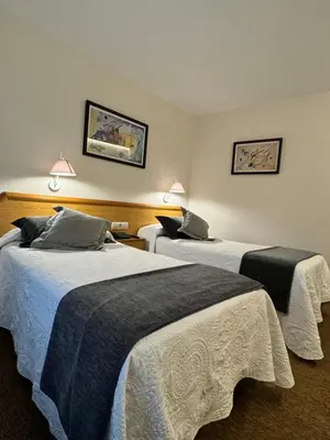 a hotel room with two beds in a room at Nest Style Santiago in Santiago de Compostela