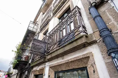 an old building with a balcony and a street light at Alda Fogar Natural in Santiago de Compostela