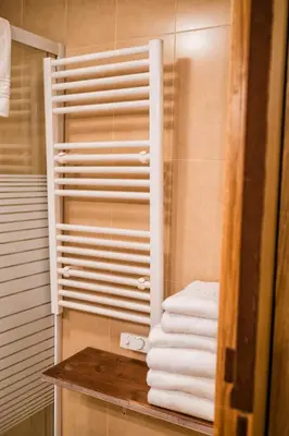 a pile of towels sitting on a counter in a bathroom at Alda Fogar Natural in Santiago de Compostela