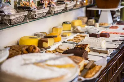 a buffet with many different types of food on plates at Hotel Monumento Pazo de Orbán in Lugo