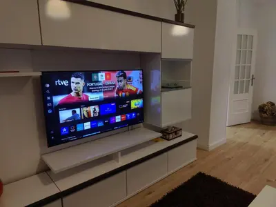 a large flat screen tv in a living room at Ático espacioso en zona céntrica in Sarria