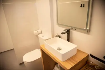 a bathroom with a sink and a toilet and a mirror at pension campillo in Fonsagrada
