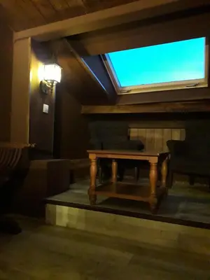 a living room with a table and a window at Hostal Medievo in Monforte de Lemos
