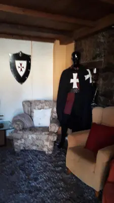 a living room with a coat and a couch at Hostal Medievo in Monforte de Lemos