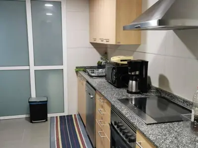 a kitchen with a stove and a counter top at Apartamento con 2 habitaciones y vistas a la Ría del Burgo in Cambre