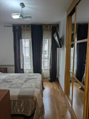 a bedroom with a bed and a large window at Apartamento con 2 habitaciones y vistas a la Ría del Burgo in Cambre