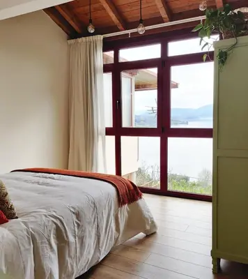 a bedroom with a bed and a large window at Casa da Ramona in Ribadavia