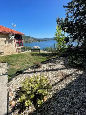 a garden with a bench and a view of a lake at Casa da Ramona in Ribadavia