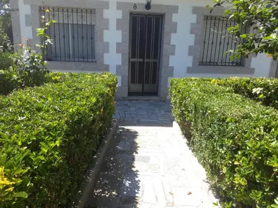 a building with a door and some bushes at Vila Montecelos in Antas de Ulla