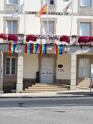 a building with rainbow flags on the front of it at Vila Montecelos in Antas de Ulla